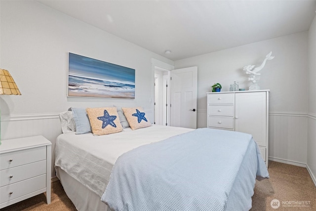 carpeted bedroom with wainscoting