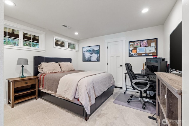 bedroom with recessed lighting, light colored carpet, and visible vents