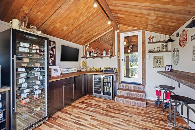 bar with a bar, beverage cooler, and wood ceiling