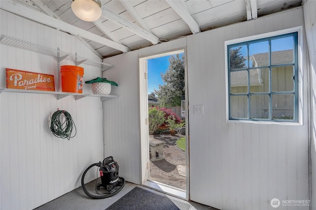 doorway featuring a wealth of natural light, wood ceiling, and vaulted ceiling with beams