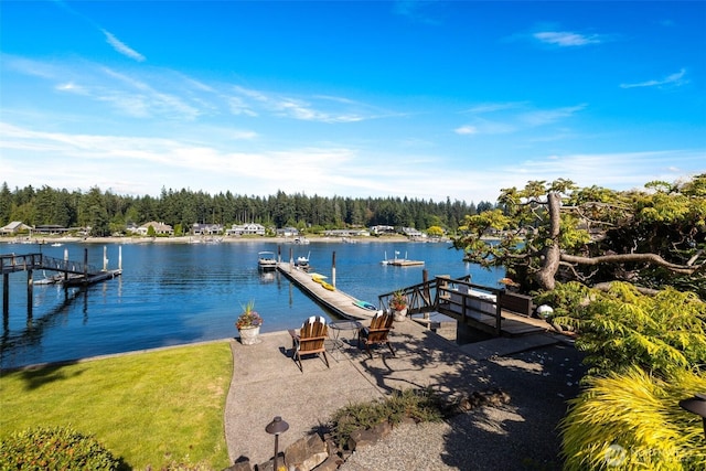 view of dock featuring a water view and a wooded view