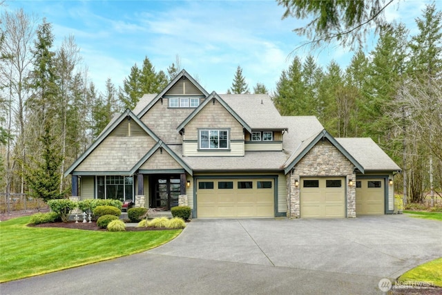 craftsman-style house with driveway, stone siding, a front lawn, and roof with shingles