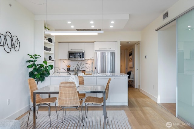 dining area featuring light wood-type flooring, visible vents, baseboards, and recessed lighting