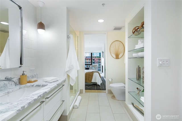 ensuite bathroom featuring visible vents, toilet, connected bathroom, vanity, and tile patterned floors