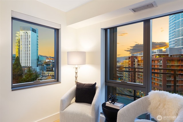 living area featuring a view of city and visible vents