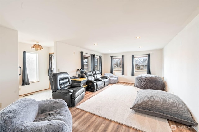 living area featuring recessed lighting, visible vents, and light wood finished floors