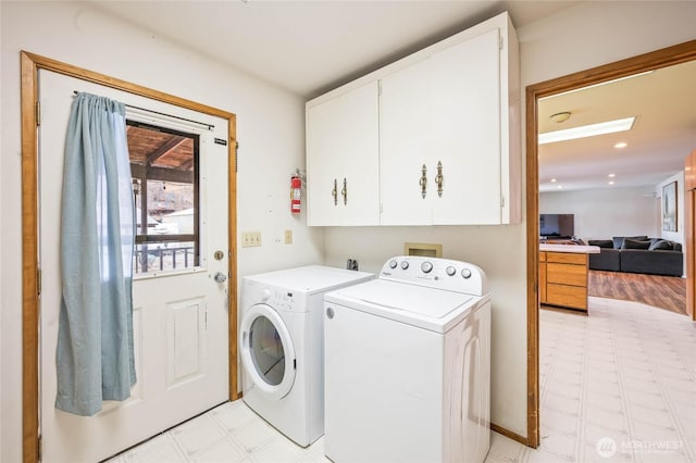 washroom with light floors, recessed lighting, cabinet space, and independent washer and dryer