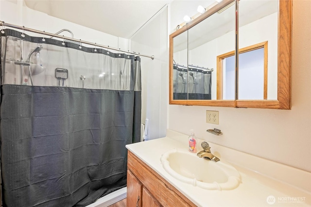 bathroom featuring curtained shower and vanity