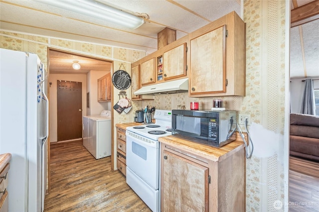 kitchen featuring under cabinet range hood, white appliances, wallpapered walls, and wood finished floors