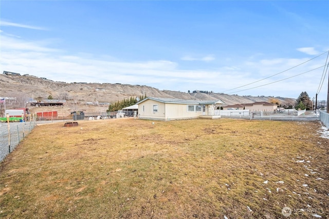 view of yard featuring fence and a mountain view