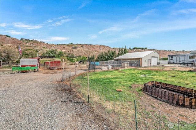 2701 Rock Island Rd, East Wenatchee, WA 98802 - view of yard with a detached garage, an outdoor structure, fence, and a mountain view