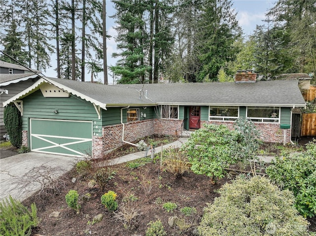 ranch-style home with fence, roof with shingles, driveway, an attached garage, and a chimney