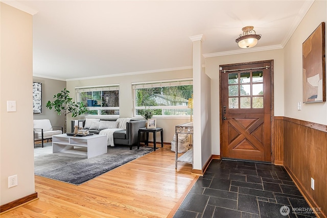 entrance foyer with a wealth of natural light, wood finished floors, and crown molding