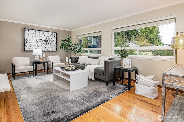 living area featuring a wealth of natural light, wood finished floors, and ornamental molding