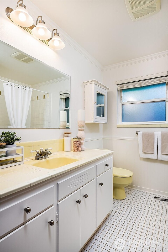 full bath featuring tile patterned floors, visible vents, toilet, crown molding, and vanity