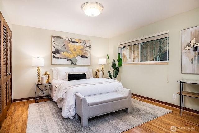 bedroom featuring a closet, baseboards, and wood finished floors