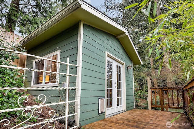 view of side of home with french doors and a wooden deck