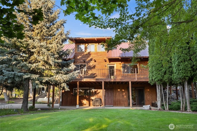 view of front of house with metal roof and a front yard