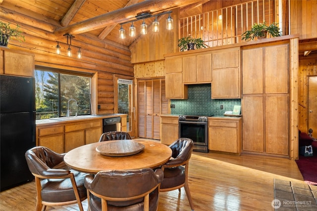 kitchen with light countertops, electric range, freestanding refrigerator, a sink, and dishwasher