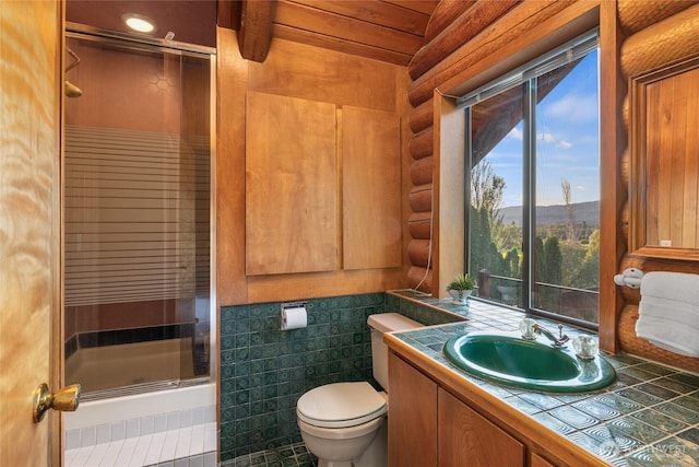 bathroom with vanity, rustic walls, a shower stall, and toilet