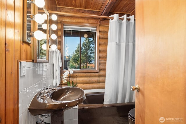 bathroom featuring wooden ceiling, toilet, and shower / bathtub combination with curtain