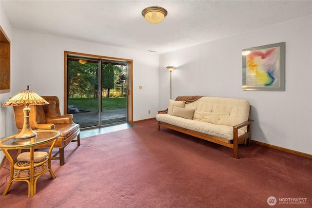 living area featuring carpet and baseboards