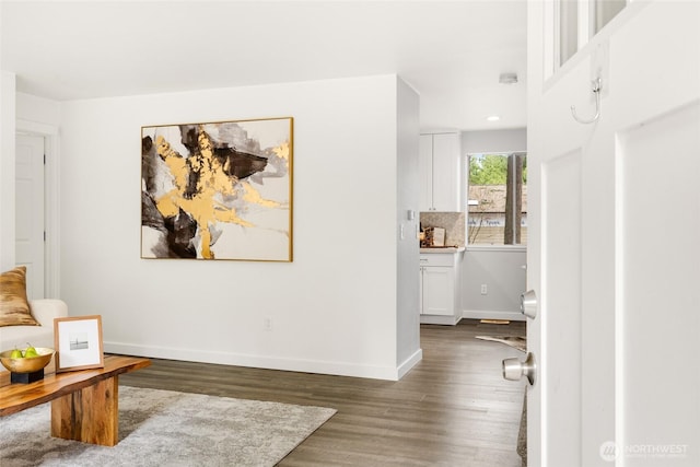 interior space with baseboards and wood finished floors