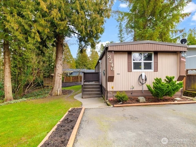 view of front of house with crawl space, a wooden deck, and a front yard