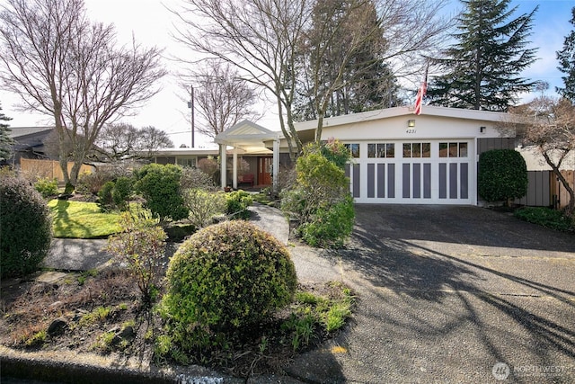 view of front of house featuring driveway, a garage, and stucco siding