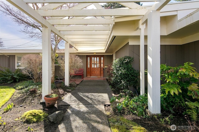 doorway to property featuring a pergola