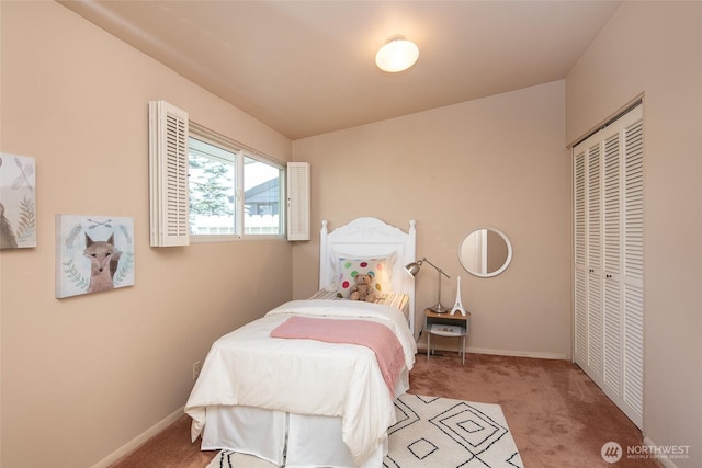 bedroom with a closet, carpet flooring, and baseboards