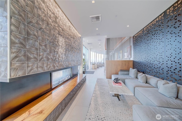 living room featuring recessed lighting, a fireplace, visible vents, and tile patterned floors