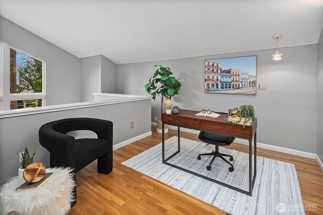 office area with baseboards and wood finished floors