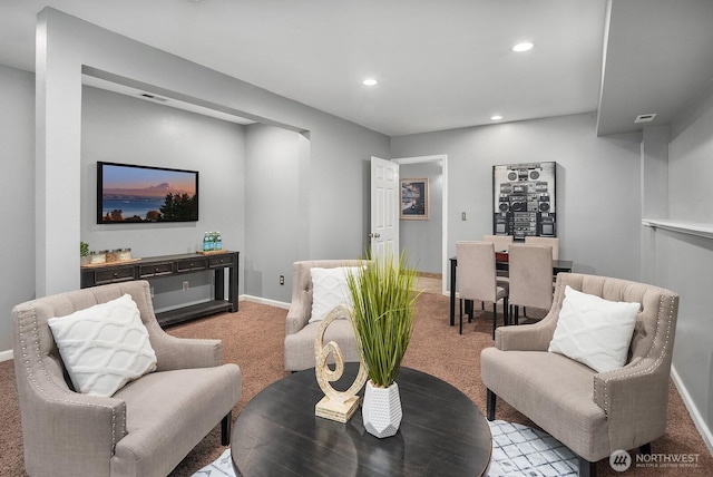 living room featuring recessed lighting, baseboards, and light colored carpet