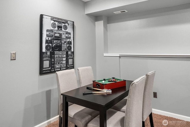 dining space with carpet flooring, visible vents, and baseboards