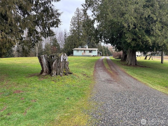 view of road with gravel driveway