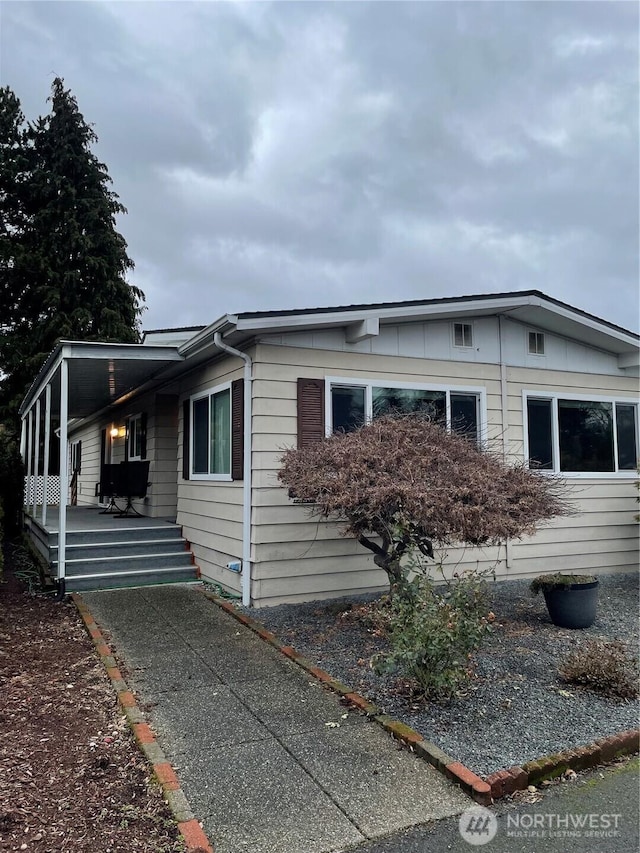 view of home's exterior featuring an attached carport