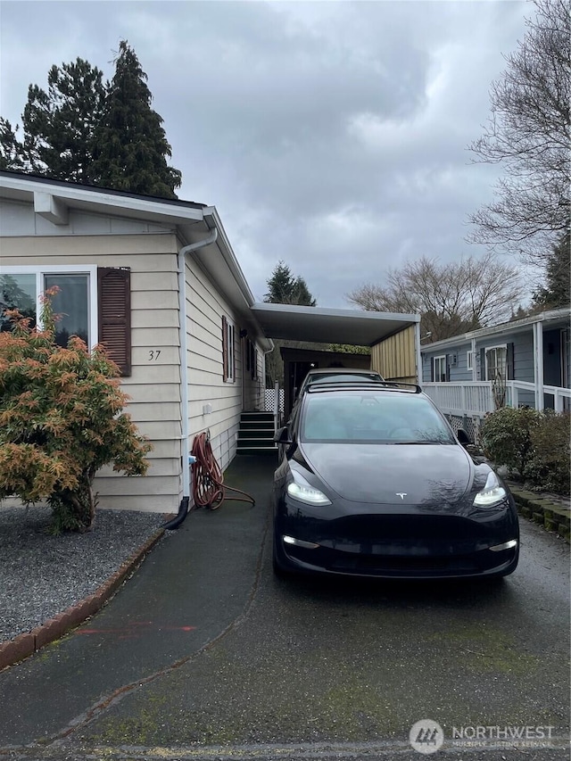 view of property exterior featuring an attached carport