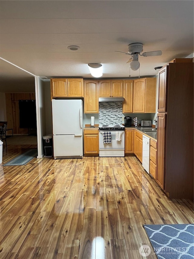 kitchen featuring decorative backsplash, light wood-style floors, ceiling fan, white appliances, and under cabinet range hood