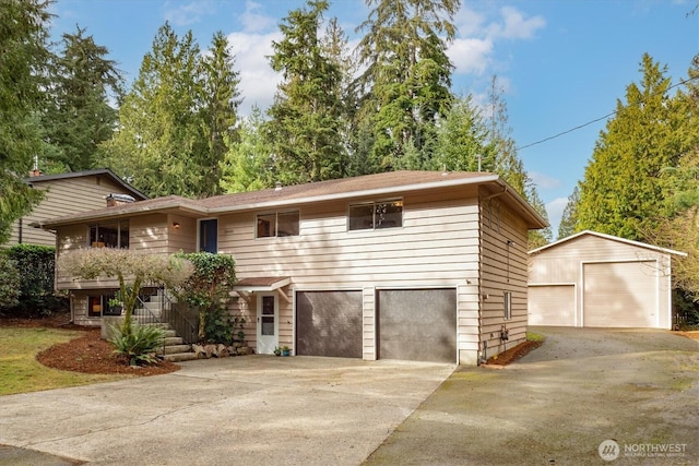 view of front of home with a garage and an outdoor structure