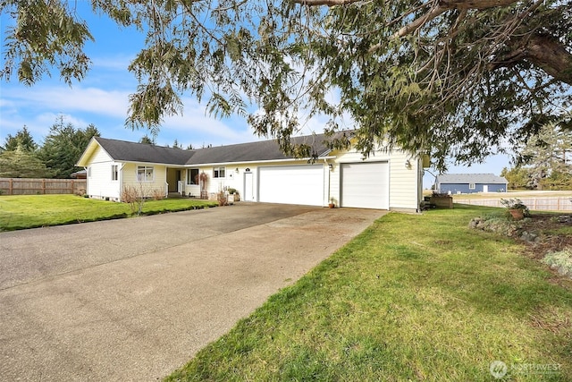 single story home with a garage, concrete driveway, a front yard, and fence