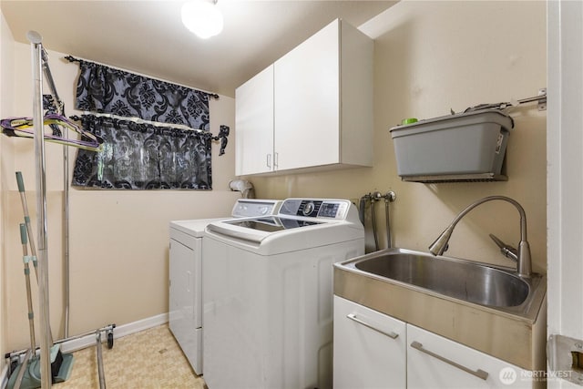 laundry room featuring cabinet space, a sink, and washing machine and clothes dryer