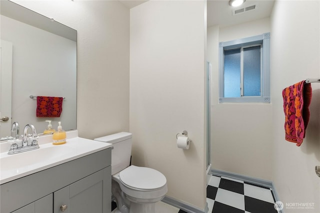 full bath with toilet, visible vents, vanity, tile patterned floors, and walk in shower