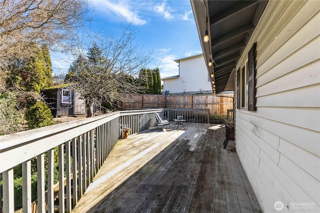 wooden terrace featuring fence