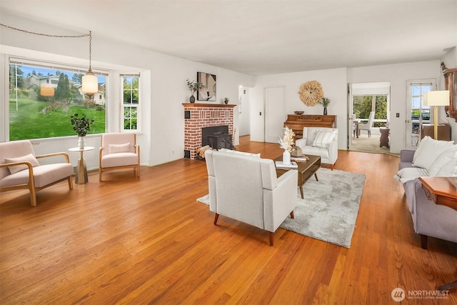 living room featuring light wood-style flooring and a fireplace