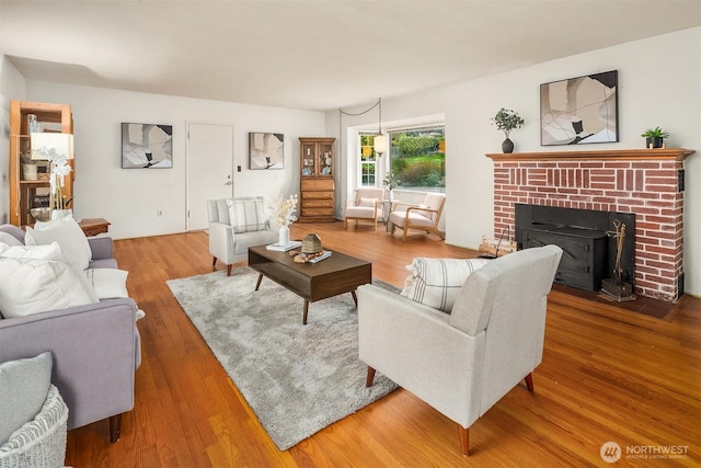 living room with wood-type flooring and a fireplace