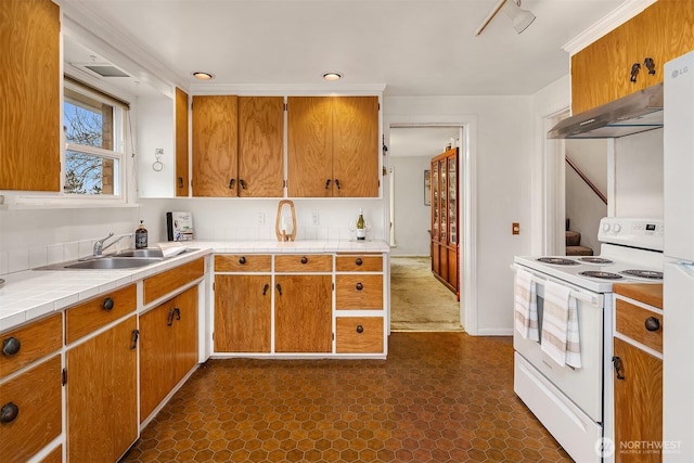 kitchen with under cabinet range hood, white range with electric stovetop, brown cabinetry, and a sink