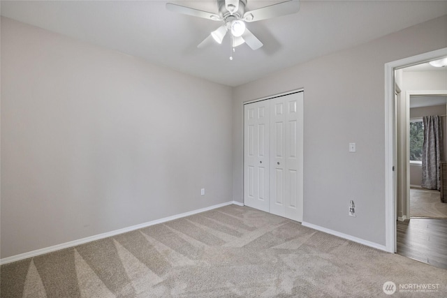 unfurnished bedroom featuring carpet floors, a closet, a ceiling fan, and baseboards