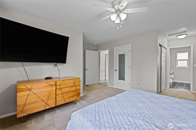 bedroom with ceiling fan, baseboards, carpet, ensuite bath, and attic access