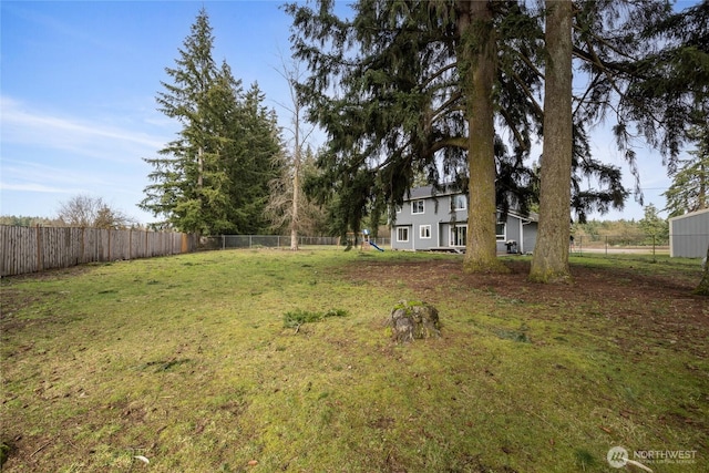 view of yard featuring a playground and fence